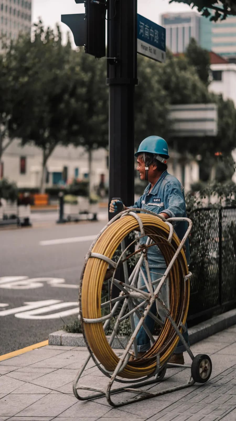 Engineer with a drain camera reel on the pavement